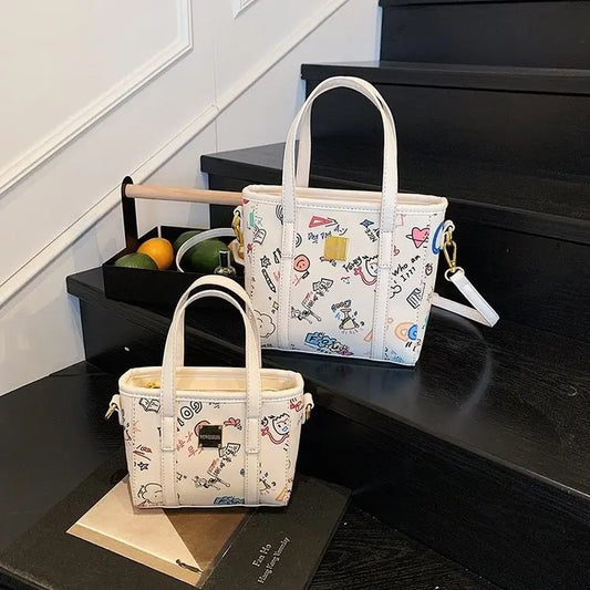 ‌Women's Fashion Bucket Bag 2025New PU Leather Graffiti Print Crossbody Bag Adjustable Long Strap Casual Purse for Work & Dating